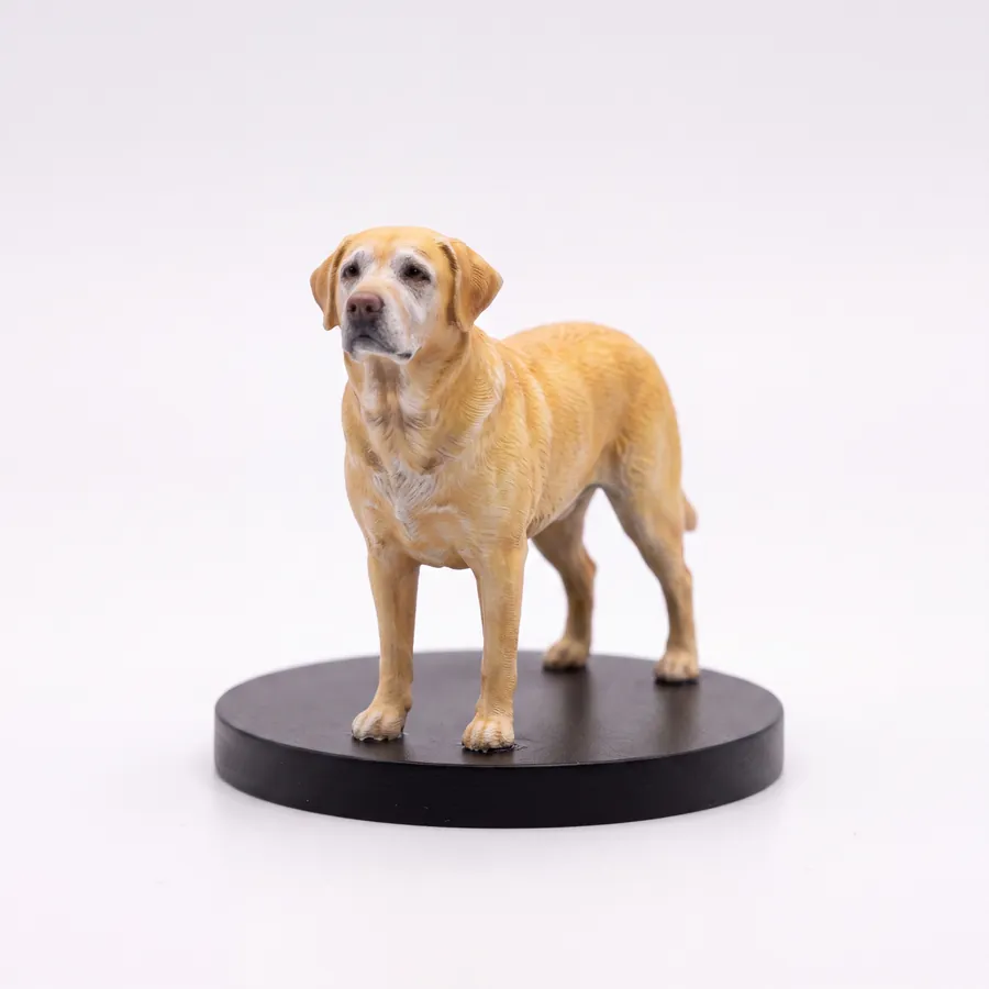 A hand-finished pet figurine held in a hand